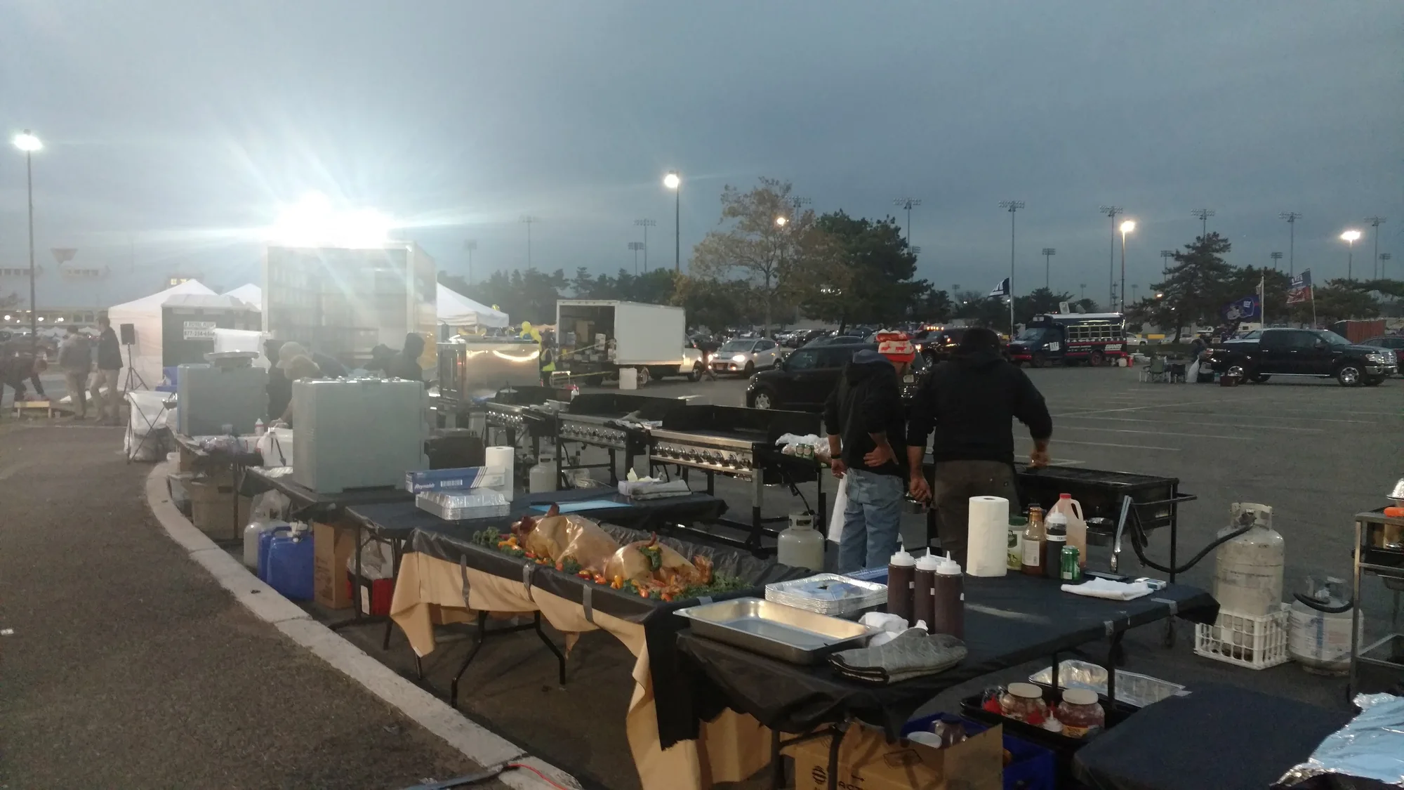 A buffet line of chafing dishes under string lights