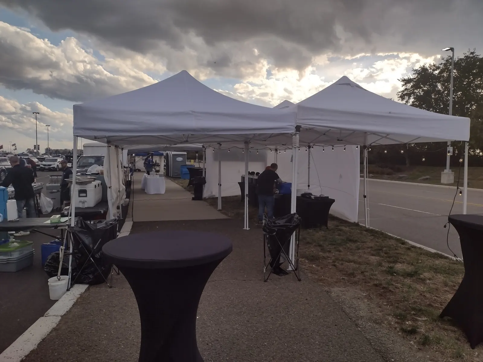 A corporate catered event under Gametime tents at dusk